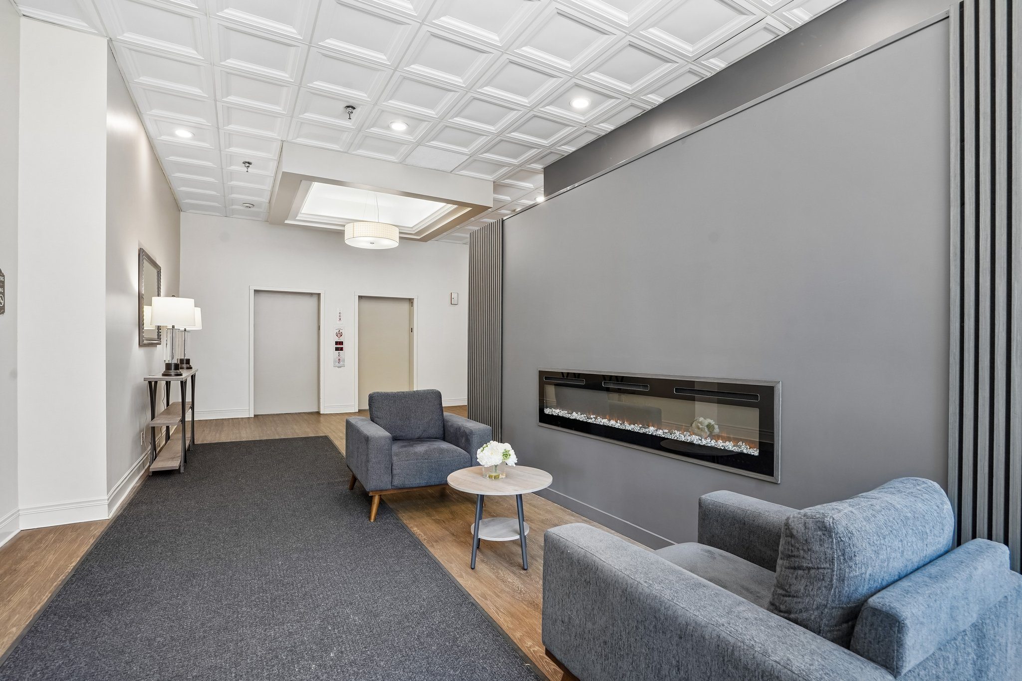Resident lounge with seating and fireplace at Irvine Park Towers